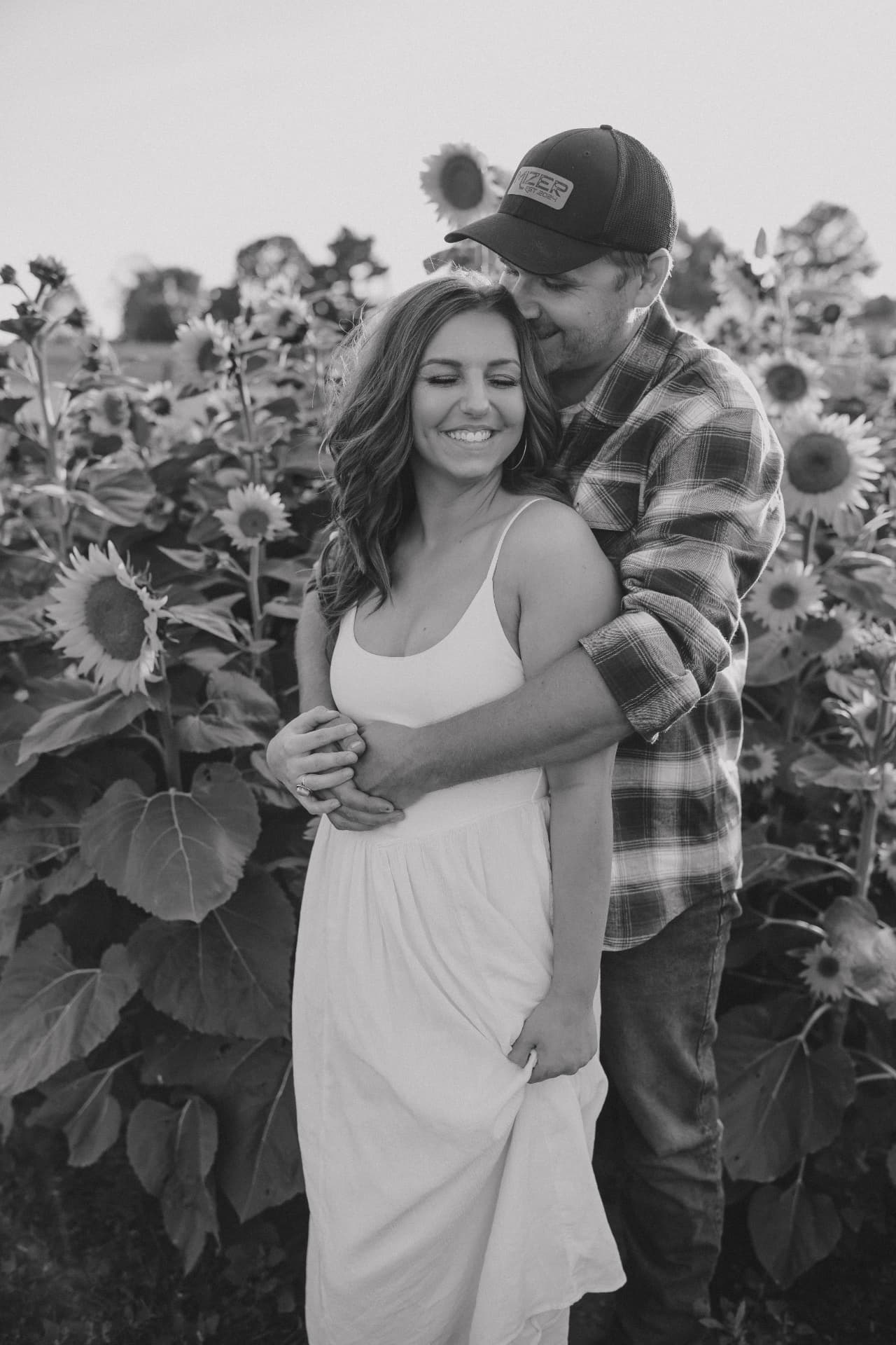 Lexi and Ryan, the couple behind Coco's Ragdolls, in a sunflower field